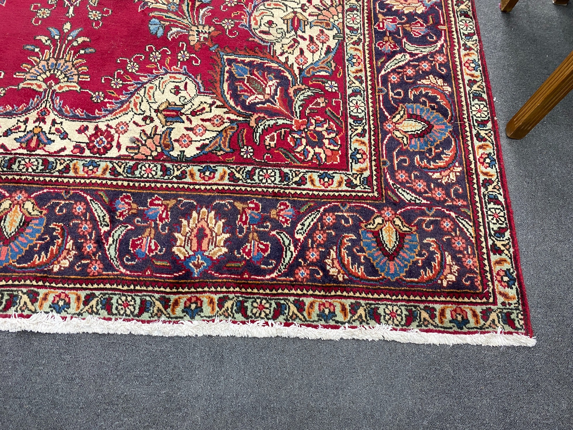 A North West Persian red ground carpet 290cm x 246cm.